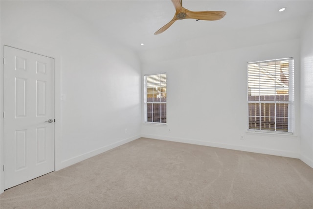 spare room featuring light colored carpet and ceiling fan