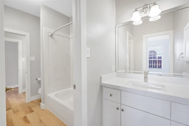 full bathroom featuring toilet, vanity, shower / bath combination, and hardwood / wood-style flooring