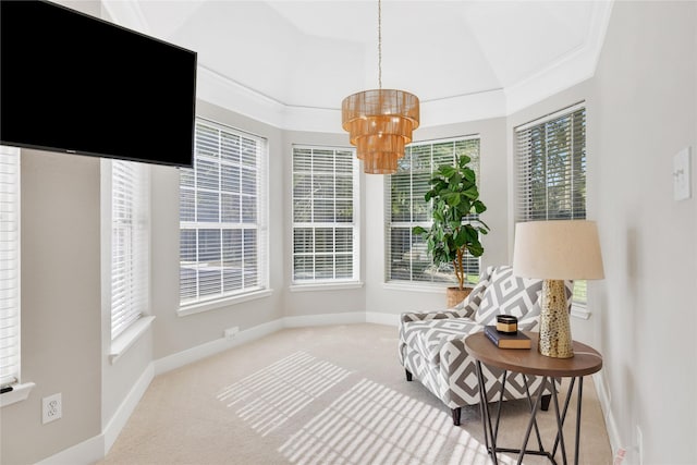 sitting room featuring a wealth of natural light, carpet, and a notable chandelier