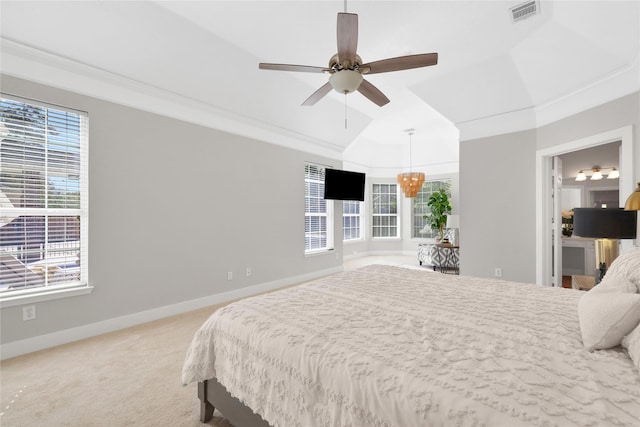 carpeted bedroom featuring ceiling fan and crown molding