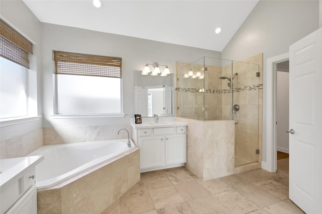 bathroom with plus walk in shower, vanity, and lofted ceiling