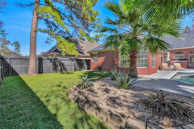 view of yard with a fenced in pool and a patio area