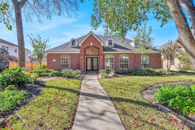 view of front of house featuring french doors and a front lawn