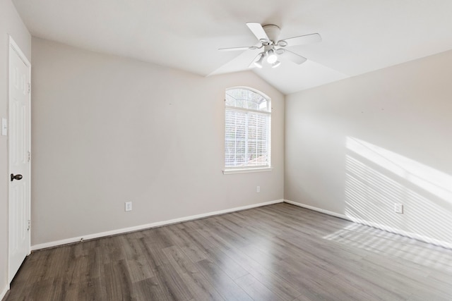 empty room with hardwood / wood-style floors, vaulted ceiling, and ceiling fan