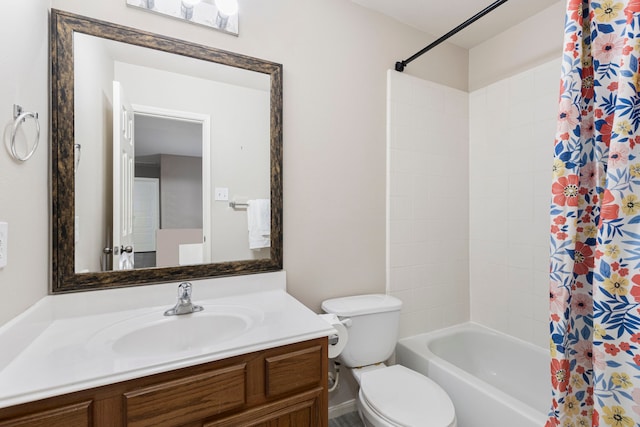 full bathroom with vanity, shower / tub combo, and toilet