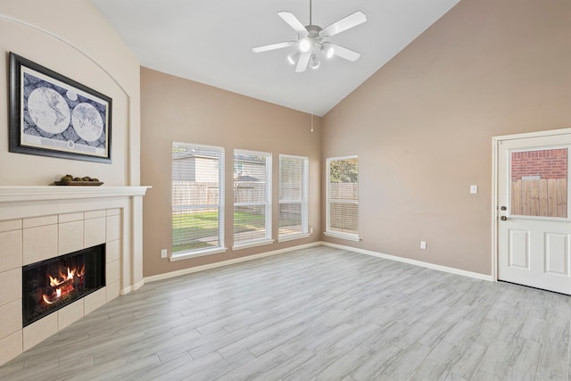 unfurnished living room featuring a fireplace, plenty of natural light, and light hardwood / wood-style floors