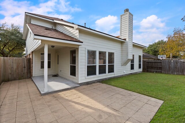 back of property featuring a lawn and a patio area