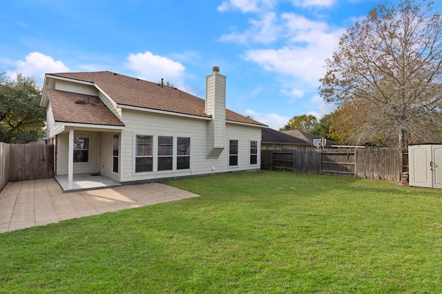 back of property with a lawn, a patio area, and a storage unit