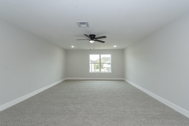 spare room featuring ceiling fan and light carpet