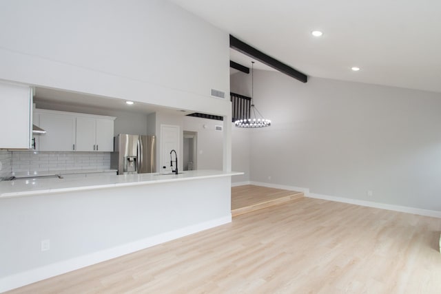 kitchen featuring white cabinets, stainless steel fridge with ice dispenser, and light hardwood / wood-style flooring