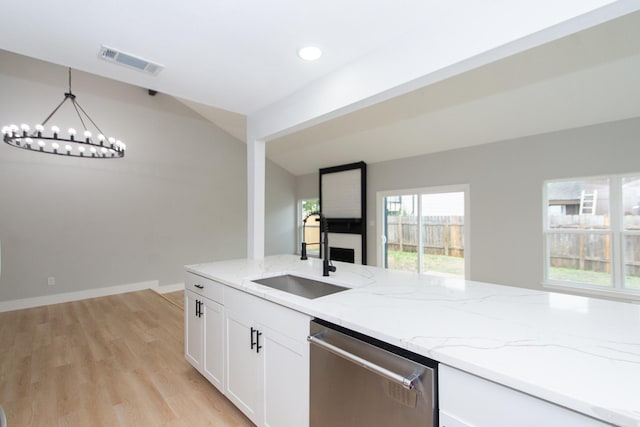 kitchen featuring hanging light fixtures, stainless steel dishwasher, plenty of natural light, and sink