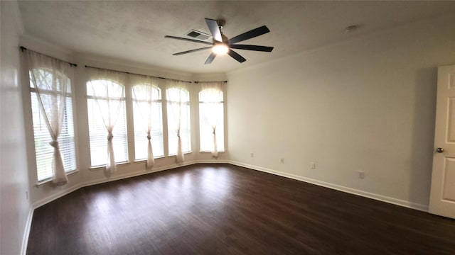 spare room featuring plenty of natural light, dark hardwood / wood-style floors, and ceiling fan