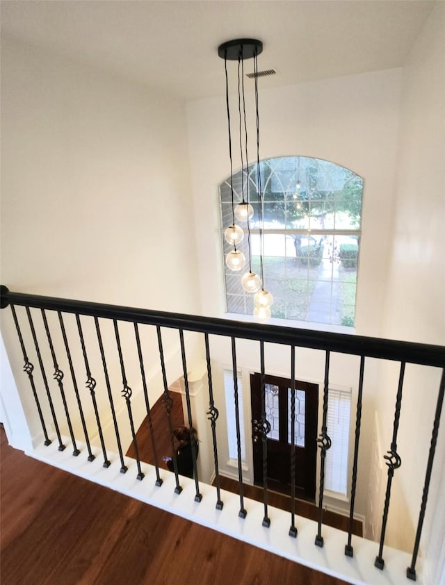 stairway with hardwood / wood-style floors