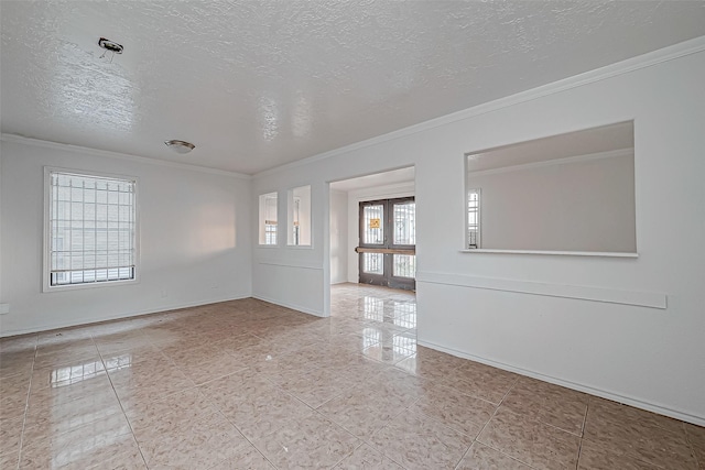 spare room featuring ornamental molding, a textured ceiling, and french doors