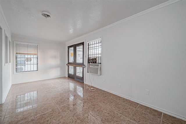 unfurnished room featuring crown molding, french doors, cooling unit, and a textured ceiling