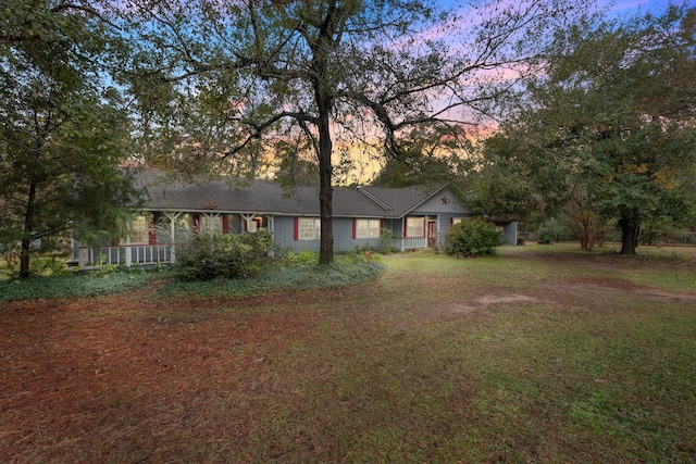 ranch-style house featuring a lawn