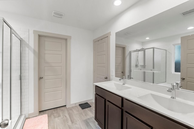 bathroom featuring vanity, wood-type flooring, and an enclosed shower