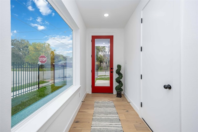 doorway to outside with light wood-type flooring