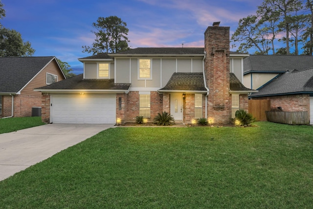 front of property featuring cooling unit, a garage, and a yard