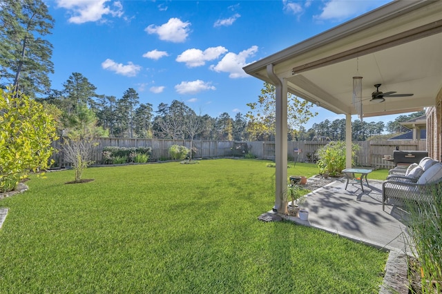 view of yard featuring ceiling fan and a patio area