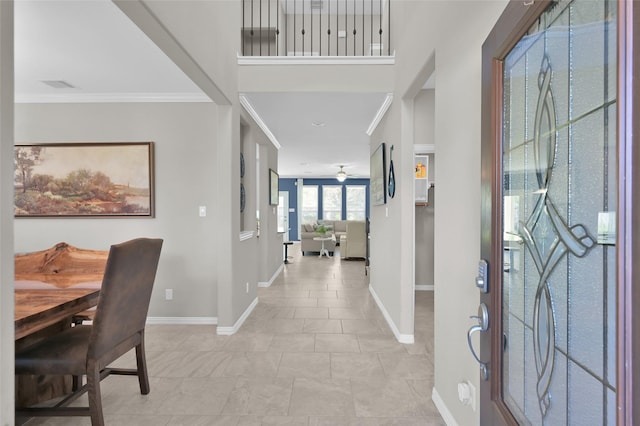 entryway featuring crown molding