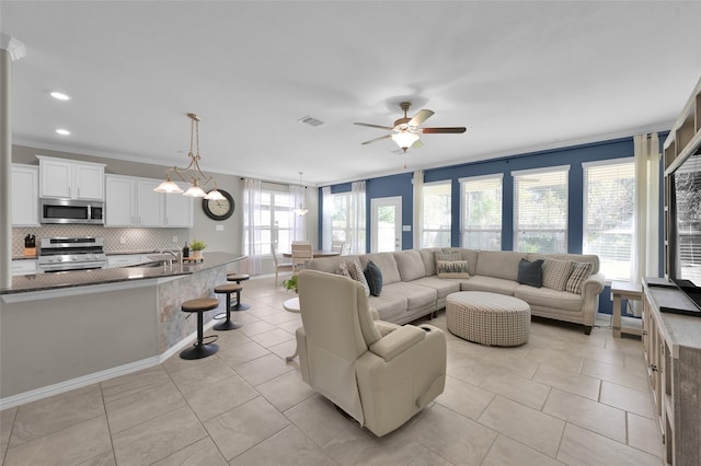 living room featuring ceiling fan, a healthy amount of sunlight, and light tile patterned flooring