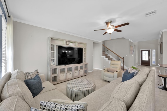 living room with crown molding and ceiling fan