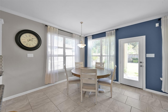 tiled dining room featuring ornamental molding and a healthy amount of sunlight