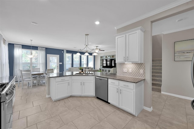 kitchen featuring appliances with stainless steel finishes, ceiling fan with notable chandelier, white cabinetry, and hanging light fixtures