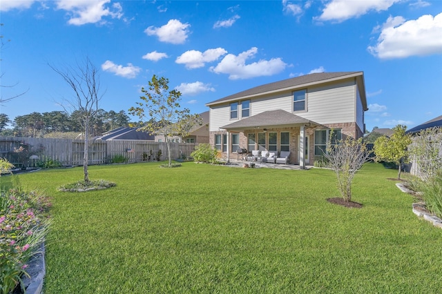 rear view of house with a yard, an outdoor hangout area, and a patio area