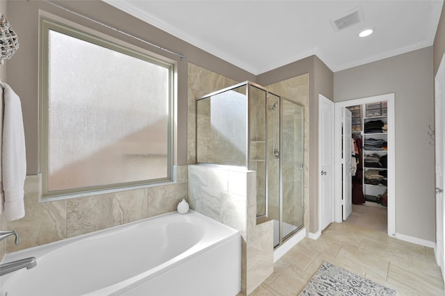 bathroom with separate shower and tub and ornamental molding