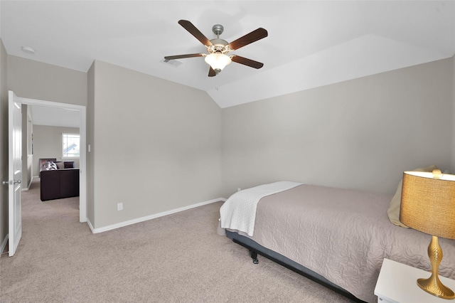 carpeted bedroom with ceiling fan and vaulted ceiling