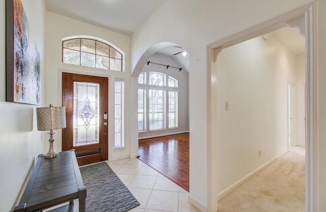 entrance foyer with light hardwood / wood-style flooring, a wealth of natural light, and lofted ceiling