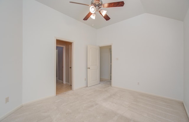 carpeted empty room featuring ceiling fan and lofted ceiling