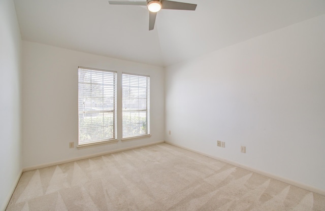 unfurnished room featuring ceiling fan, light colored carpet, and vaulted ceiling