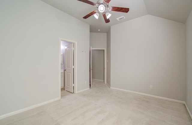 unfurnished bedroom featuring ceiling fan, light colored carpet, and lofted ceiling