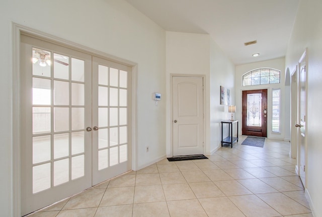 tiled entrance foyer featuring ceiling fan and french doors