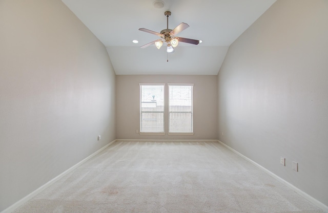 unfurnished room featuring ceiling fan, light carpet, and vaulted ceiling