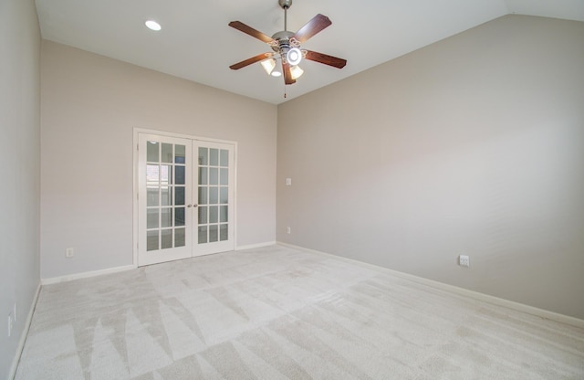 empty room featuring ceiling fan, french doors, light colored carpet, and vaulted ceiling