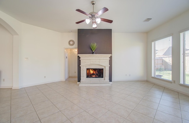 unfurnished living room with light tile patterned floors and ceiling fan