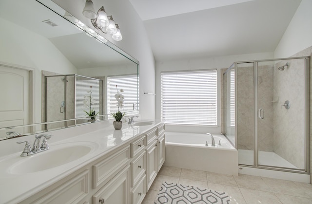 bathroom featuring tile patterned floors, vanity, shower with separate bathtub, and vaulted ceiling