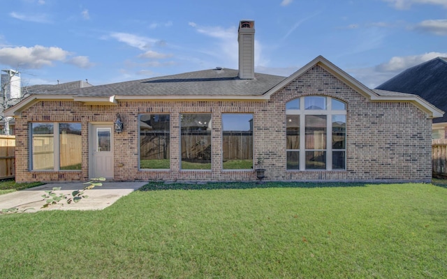 rear view of property featuring a yard and a patio