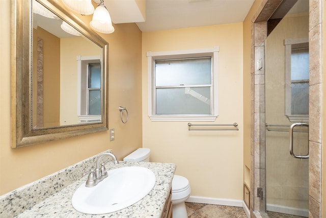 bathroom with toilet, vanity, and walk in shower