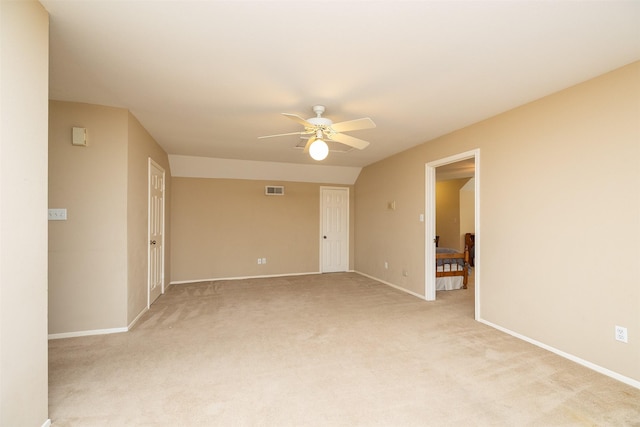 carpeted spare room featuring ceiling fan