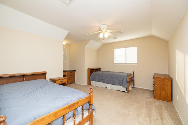 carpeted bedroom with ceiling fan and vaulted ceiling