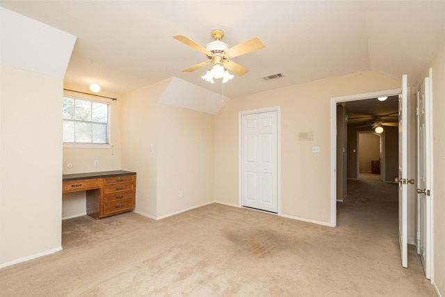 unfurnished bedroom with ceiling fan, a closet, light colored carpet, and lofted ceiling