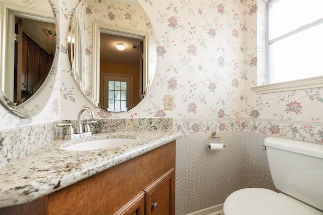 bathroom featuring vanity and toilet