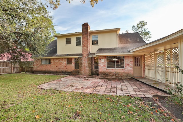 rear view of house with a patio area and a yard