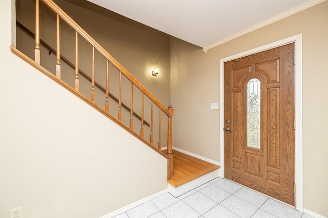 entryway with light tile patterned flooring and crown molding