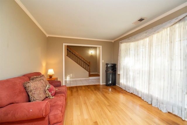 living room with wood-type flooring and ornamental molding